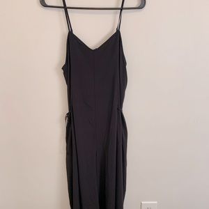 Black Athleta size 2 strappy wide leg jumpsuit with cutout back and side ties.